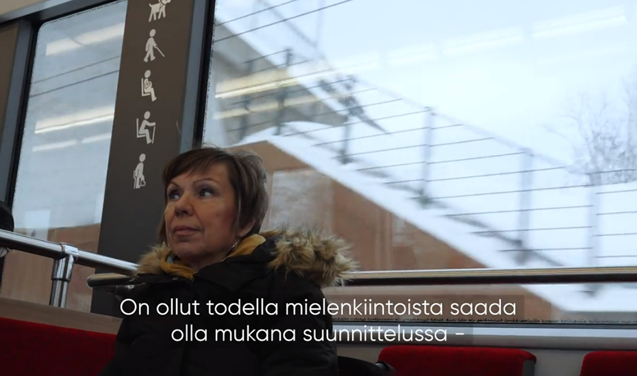 Screenshot from the The Way We Move film where a passenger is sitting in the tram.